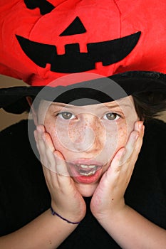 Frightened boy with pumpkin hat