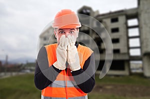 Frightened builder looking shocked