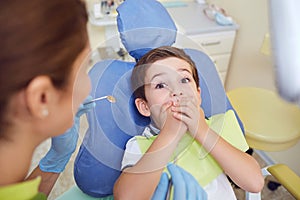 Frightened child boy in dental clinic.