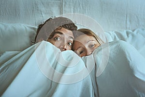 Frightened couple with eyes wide open