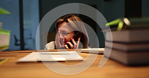 Frightened crying woman calls rescue service or friends on mobile phone during thunderstorm in office