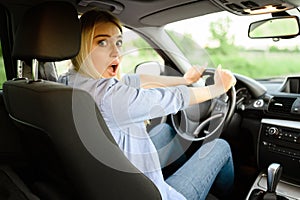 Frightened female student in car, driving school