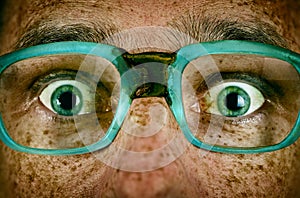 Frightened look of a man in old glasses photo