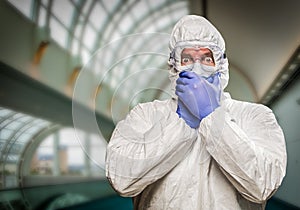 Frightened Man Covering Mouth With Hands Wearing HAZMAT Protective Suit