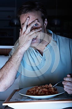 Frightened Man Enjoying Meal Watching TV