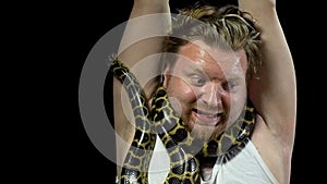 Frightened man with snake on his neck