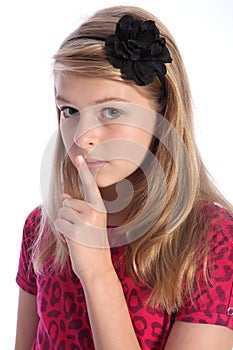 Frightened school girl child makes keep quiet sign photo