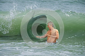 Frightened swimmer man getting hit by wave with attacking shark