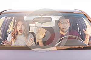 Frightened terrified couple in car can`t control speed, drive fast, afraid of being safe, scream with shock as have accident, bein