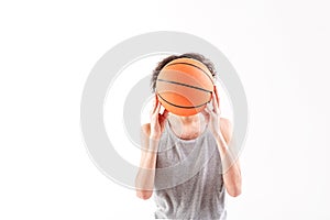 Frightened thin guy closing head by ball