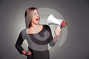 Frightened woman looking on megaphone