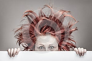 Frightened woman with messy hair photo