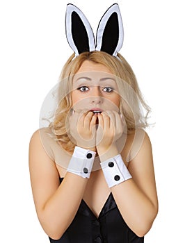 Frightened young girl in rabbit costume on white
