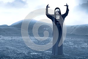 Frightening devil nun on the spooky hills