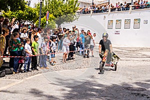 FRIGILIANA, SPAIN - MAY 13, 2018 `Autos Locos` - traditional fun involving the ride of cardboard cars in small spanish town