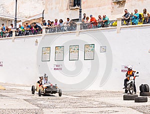 FRIGILIANA, SPAIN - MAY 13, 2018 `Autos Locos` - traditional fun involving the ride of cardboard cars in small spanish town