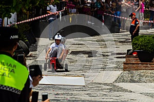 FRIGILIANA, SPAIN - MAY 13, 2018 `Autos Locos` - traditional fun involving the ride of cardboard cars in small spanish town