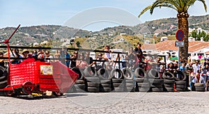 FRIGILIANA, SPAIN - MAY 13, 2018 `Autos Locos` - traditional fun involving the ride of cardboard cars in small spanish town