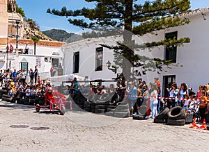 FRIGILIANA, SPAIN - MAY 13, 2018 `Autos Locos` - traditional fun involving the ride of cardboard cars in small spanish town