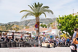 FRIGILIANA, SPAIN - MAY 13, 2018 `Autos Locos` - traditional fun involving the ride of cardboard cars in small spanish town