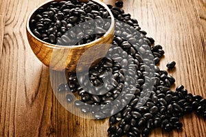 Black beans on wooden background photo