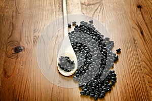 Black beans on wooden background photo