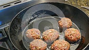 Frikadeller in a black pan