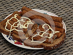 frikandel on bread with mayonnaise, a traditional Dutch snack, a sort of minced meat hot dog