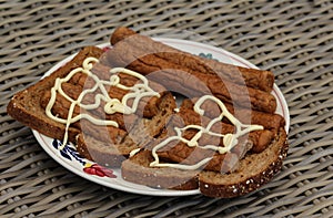 frikandel on bread with mayonnaise, a traditional Dutch snack, a sort of minced meat hot dog