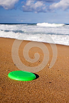 A Frisbee on the beach sand