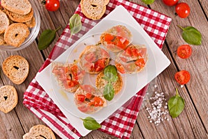 Friselle with cherry tomatoes and basil.