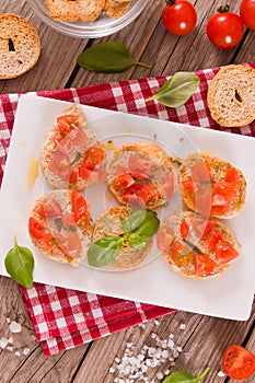 Friselle with cherry tomatoes and basil.