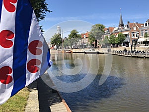Frisian flag at canal Het Grootdiep in Dokkum