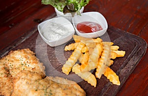 Fritters fish steak served with french fries. - Selective focus