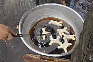 Fritters frying in an oil in a frying pan at a street stall in Phnom Penh