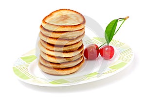 Fritters on a plate with cherries isolated white background