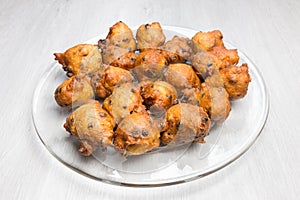 Fritters with raisins and currants on glass scale
