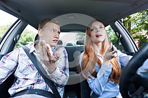 Frivolous woman making up in car