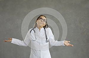 Frivolous young female doctor who has no answer and does not know the correct diagnosis. photo