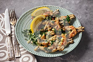 Frog legs baked with garlic butter and parsley.