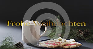Frohe weihnacthen text in gold over christmas hot chocolate and cookies