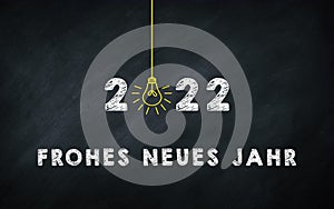 Frohes neues Jahr 2022. Happy New Year in Germany Idiom On chalkboard. Creative Concept. 2022 Light Bulb On Blackboard with German