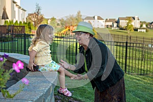 Frolicsome Toddler Girl Hiding Her Shoes from her Grandmother