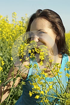 Frolicsome young girl in the middle of yellow flowers