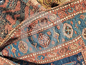 Front and back of colorful antique used carpets