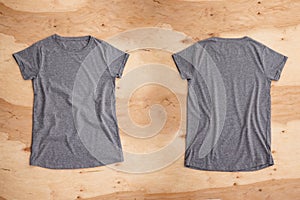 Front and back of dark grey melange empty T-shirt on wooden background