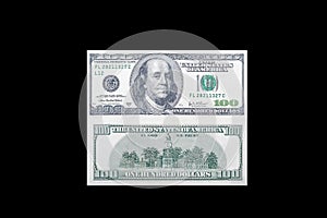 Front and back side of a 100 USA dollar bill with a portrait of American President Benjamin Franklin on an isolated black backgrou