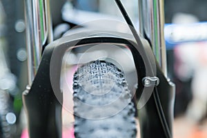 Front bicycle wheel on a blurred background