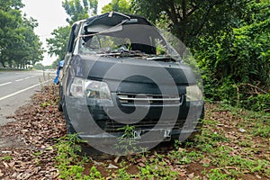 Front of black car get damaged by accident on the road