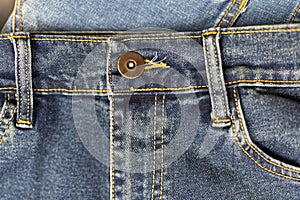 Front of blue jeans with button and belt loops